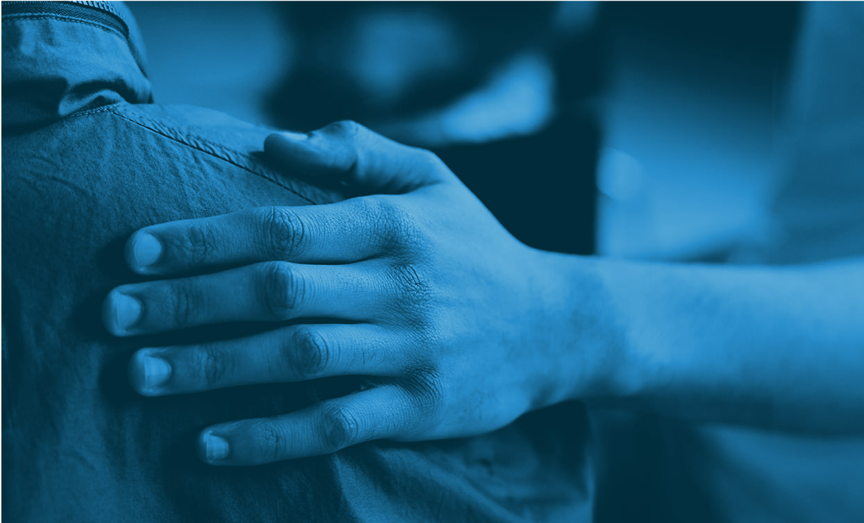 a picture of a hand on another person's shoulder