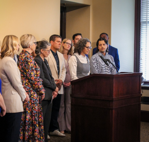 Bridge building leaders standing at podium or a press conference
