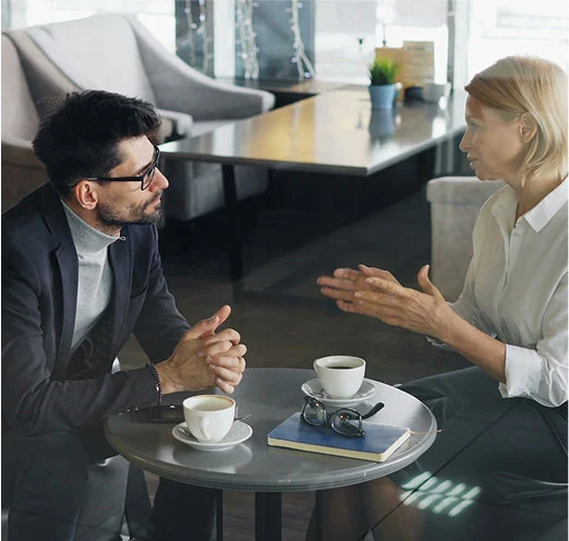 two people discussing sitting down